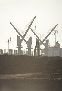Silhouettes of cranes and logs in the operating harbour, Portland, SA. Photo credit M.Jenner