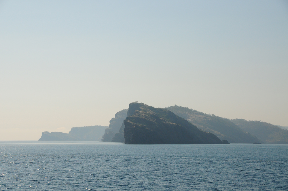 In the smoky morning haze from nearby bushfires, the islands of the Buccaneer Archipelago appear many tones of grey.
