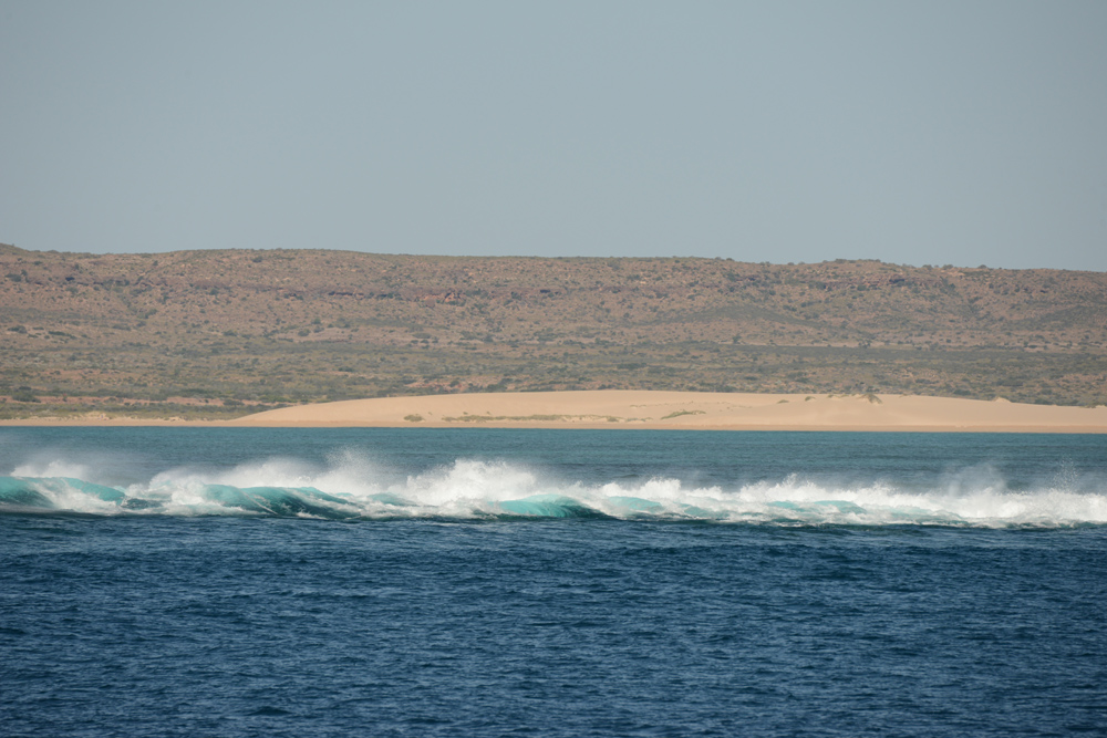 The waves breaking on Ninglaoo Reef with Cape Range beyond, stunning scenery of the west side.